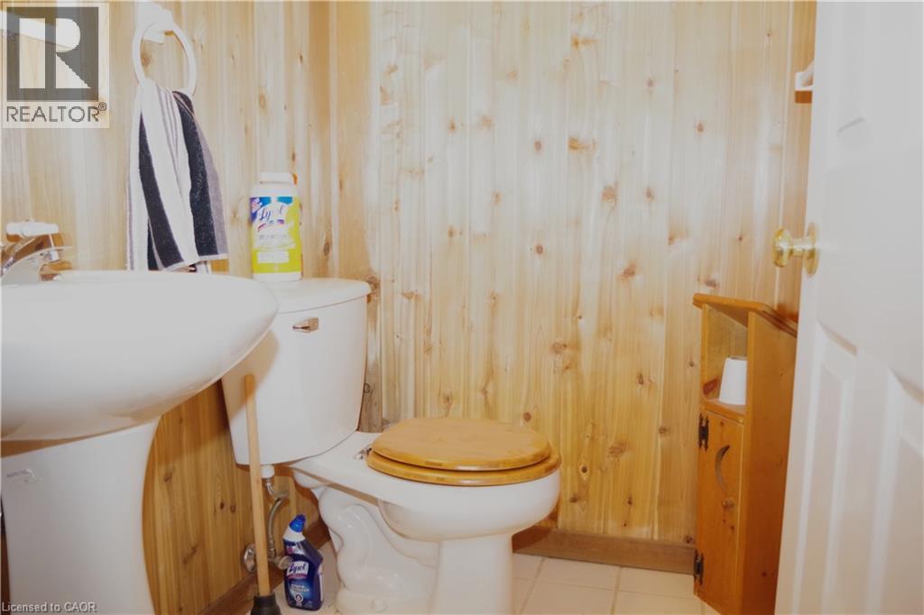 Bathroom featuring wood walls, tile patterned flooring, and vanity - 425 Wellington Street E, Mount Forest, ON - Indoor