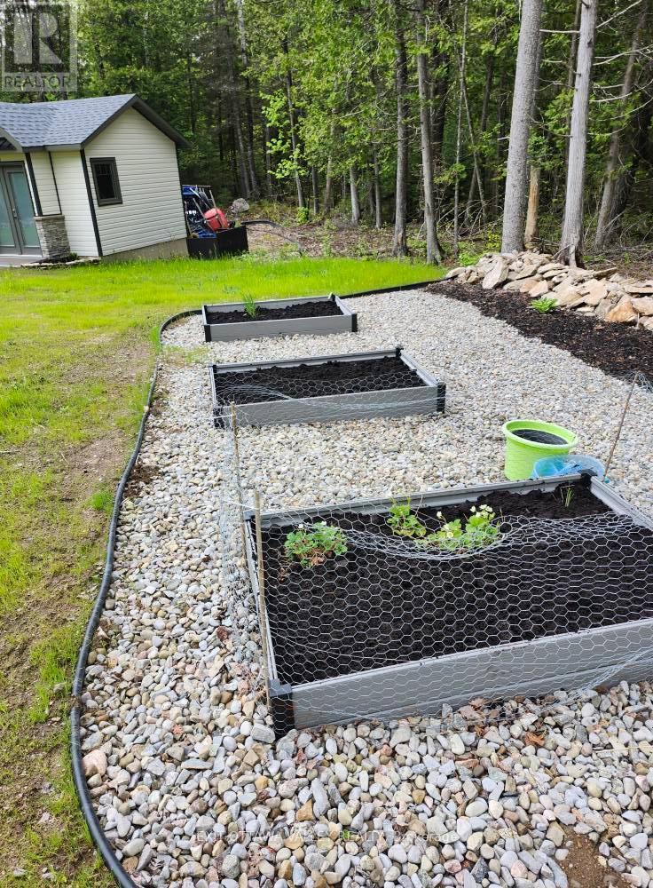 Garden area with stone retaining wall. - 1485 Rapid Road, Whitewater Region, ON - Outdoor