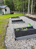 Garden area with stone retaining wall. -