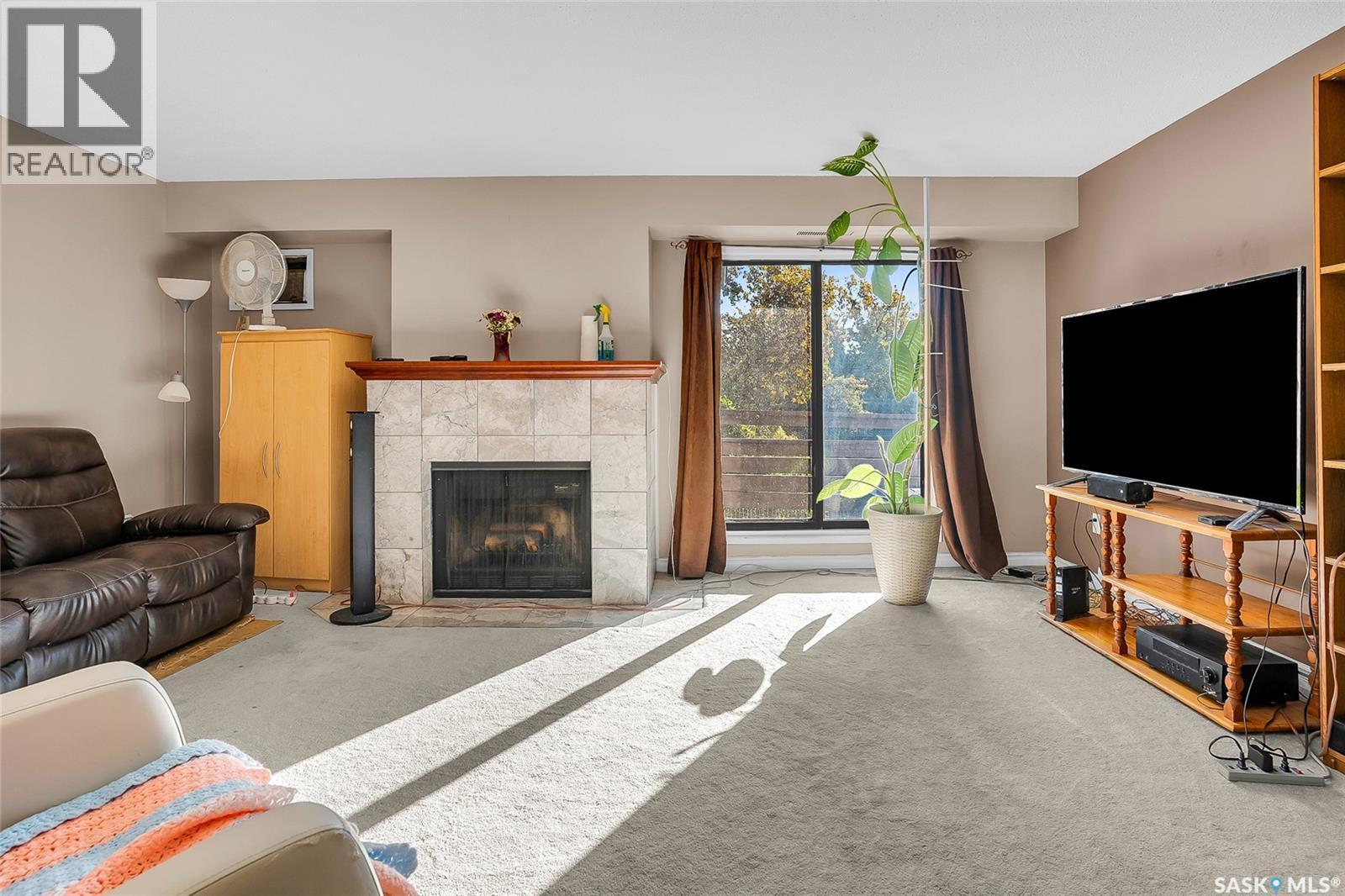302 437 Pendygrasse Road, Saskatoon, SK - Indoor Photo Showing Living Room With Fireplace