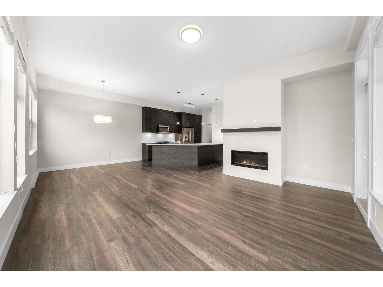 312 2120 Gladwin Road, Abbotsford, BC - Indoor Photo Showing Other Room With Fireplace