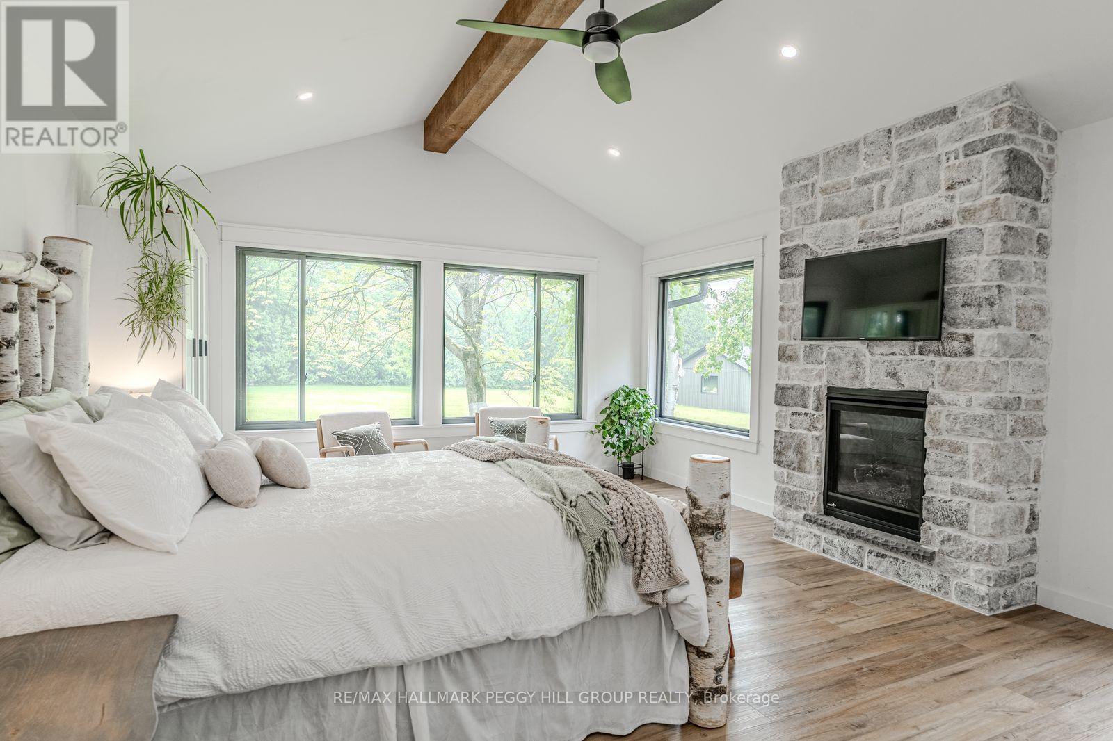 2764 Fairgrounds Road, Severn, ON - Indoor Photo Showing Bedroom With Fireplace