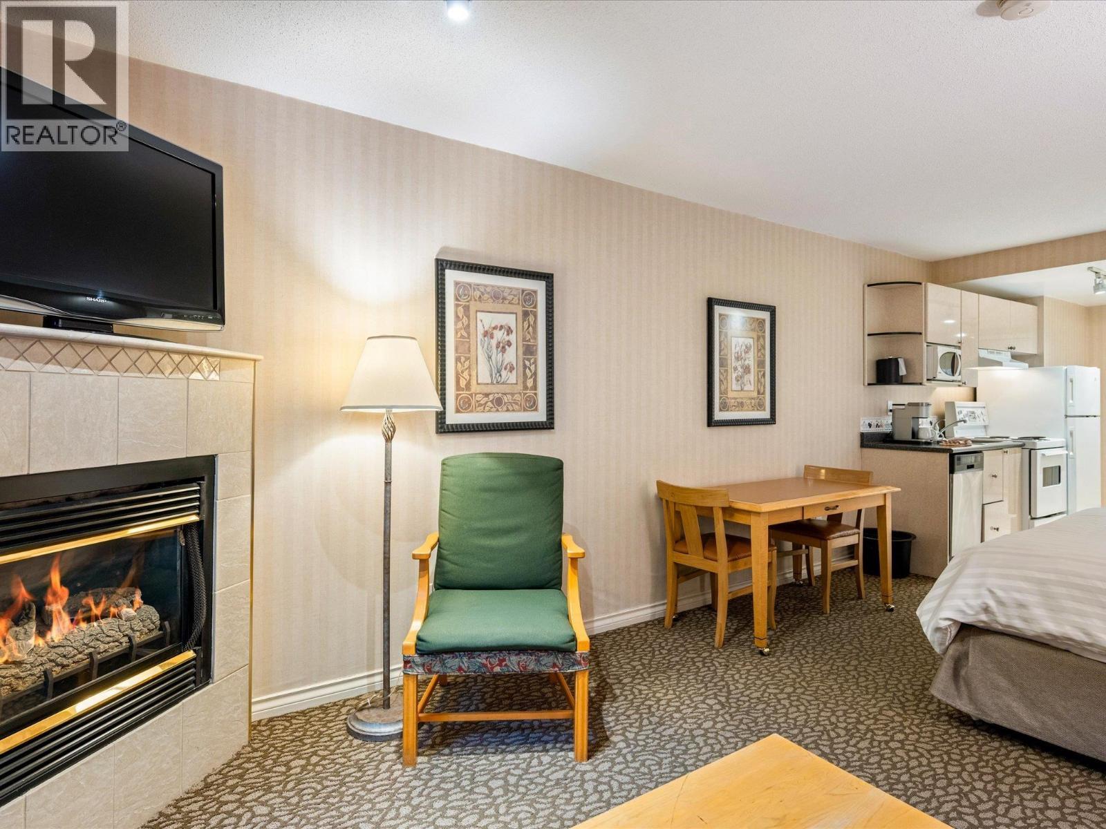 215 4319 Main Street, Whistler, BC - Indoor Photo Showing Other Room With Fireplace