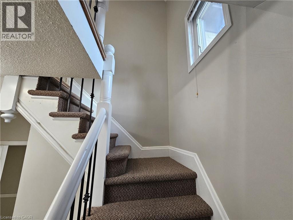 another view of stairs with bright window on stairs - 100 E Lancaster Street E, Kitchener, ON