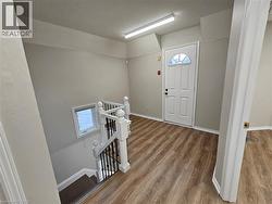 landing at top of stairs with door to upper balcony. -