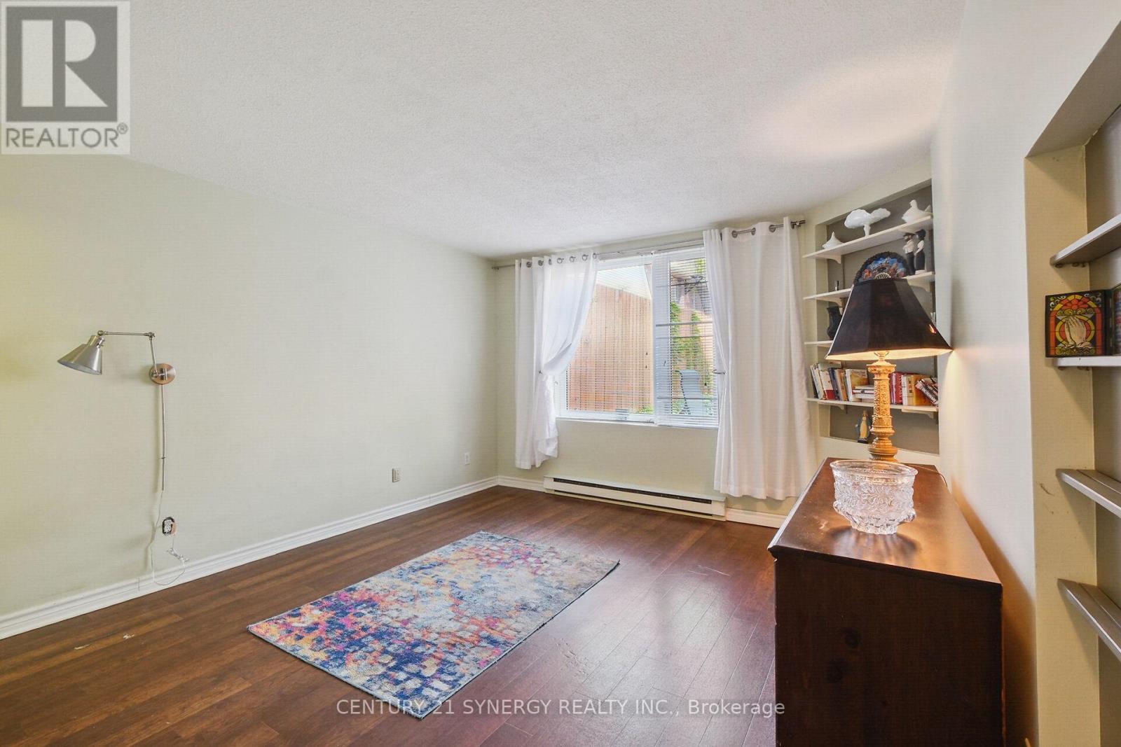 a large window to look outside at the garden beds - 104 - 295 Gilmour Street, Ottawa, ON - Indoor Photo Showing Other Room