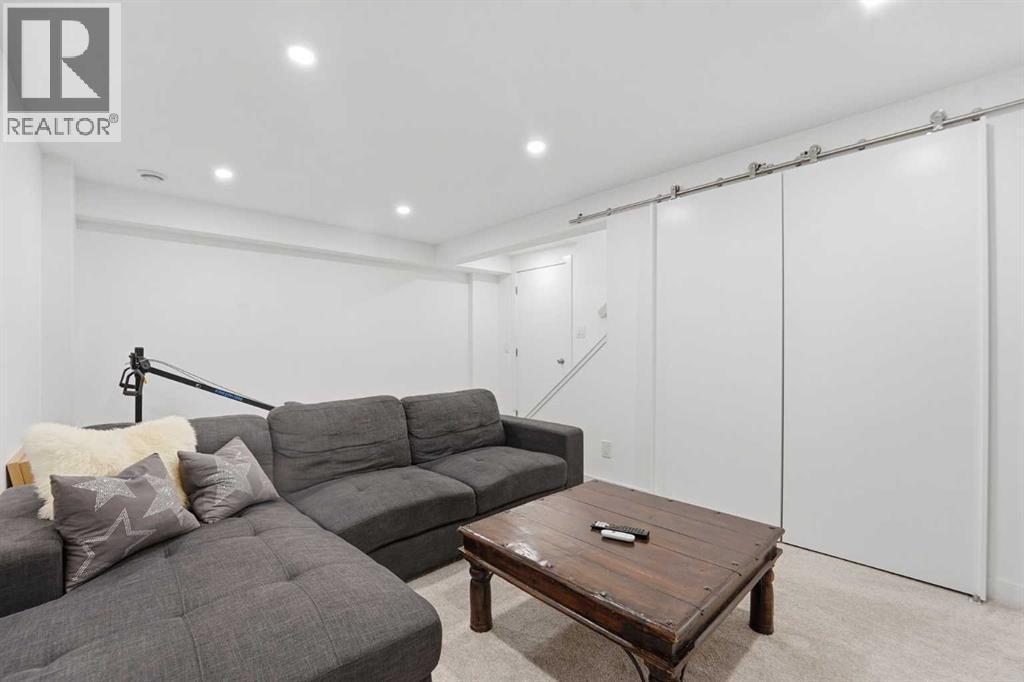 Storage Under the Staircase with Modern Barn Door - 86, 630 Sabrina Road Sw, Calgary, AB - Indoor Photo Showing Living Room