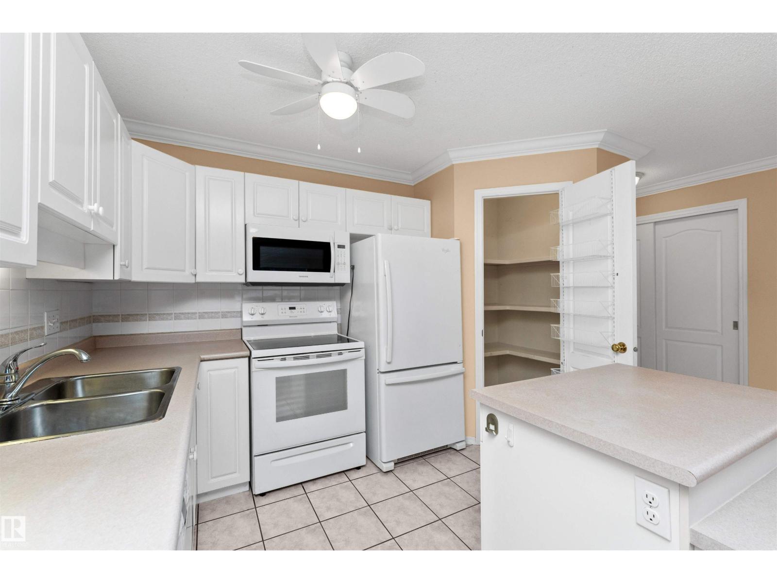 #304 20 St Joseph St, St. Albert, AB - Indoor Photo Showing Kitchen With Double Sink
