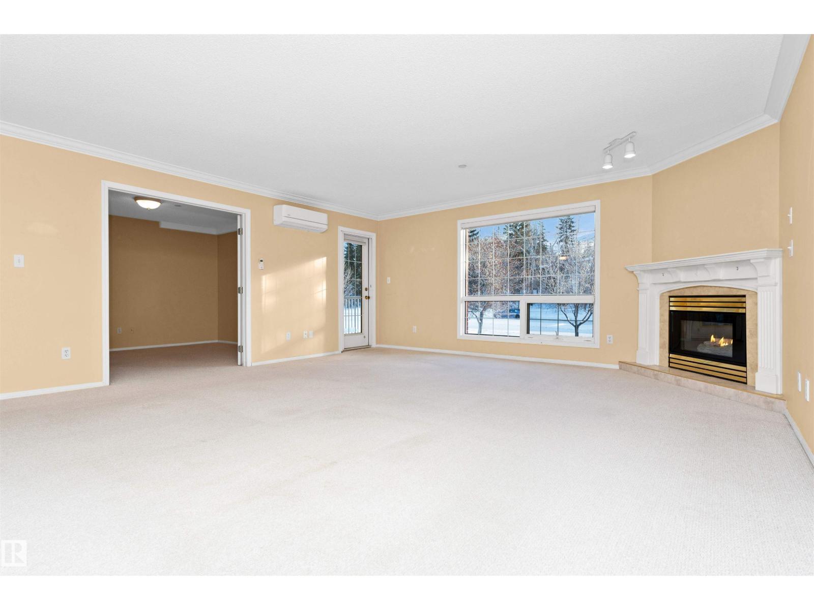 #304 20 St Joseph St, St. Albert, AB - Indoor Photo Showing Living Room With Fireplace