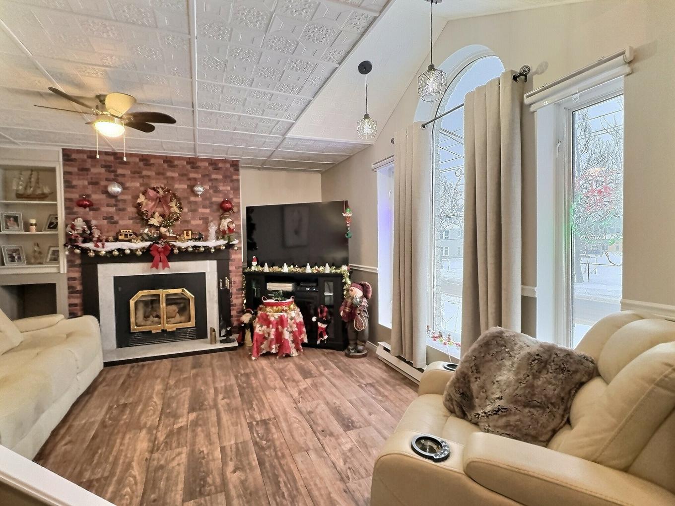Living room - 22 Rue St-Isidore O., Laverlochère-Angliers, QC - Indoor Photo Showing Living Room With Fireplace