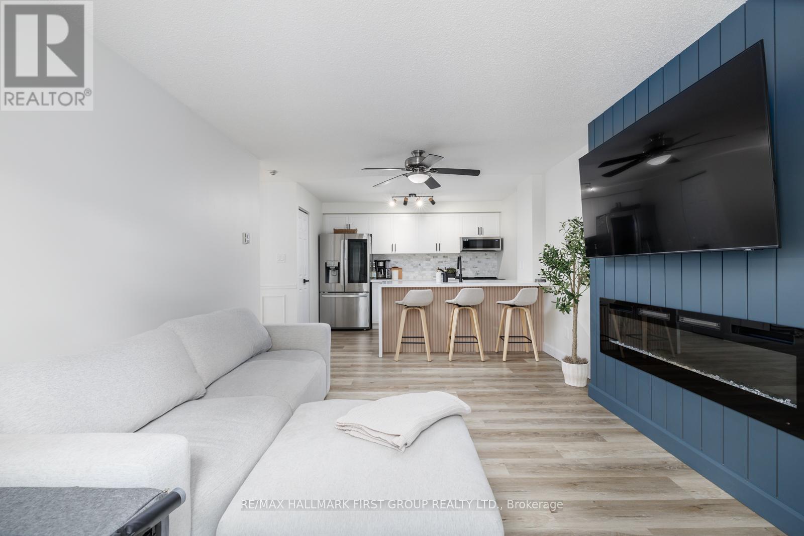 208 - 91 Aspen Springs Drive, Clarington, ON - Indoor Photo Showing Living Room With Fireplace