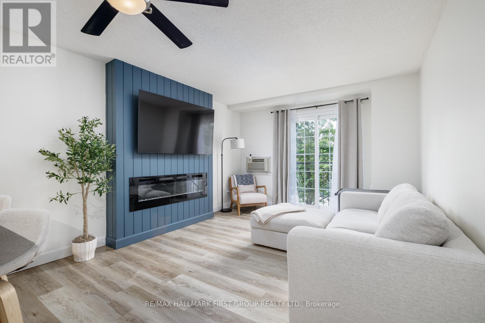 208 - 91 Aspen Springs Drive, Clarington, ON - Indoor Photo Showing Living Room With Fireplace