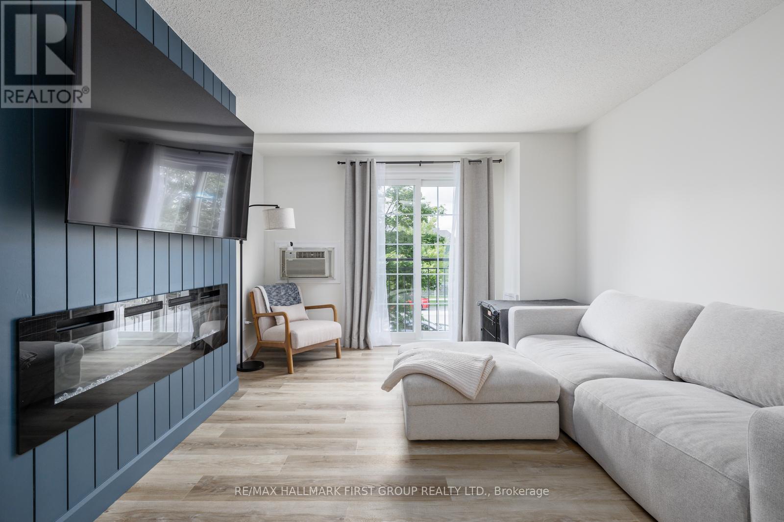 208 - 91 Aspen Springs Drive, Clarington, ON - Indoor Photo Showing Living Room With Fireplace