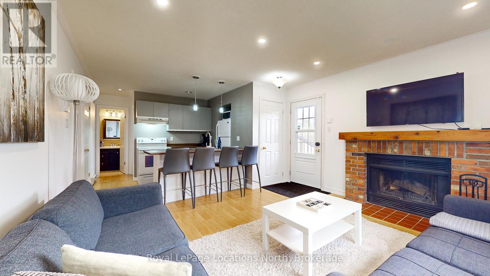 101 - 23 Dawson Drive, Collingwood, ON - Indoor Photo Showing Living Room With Fireplace