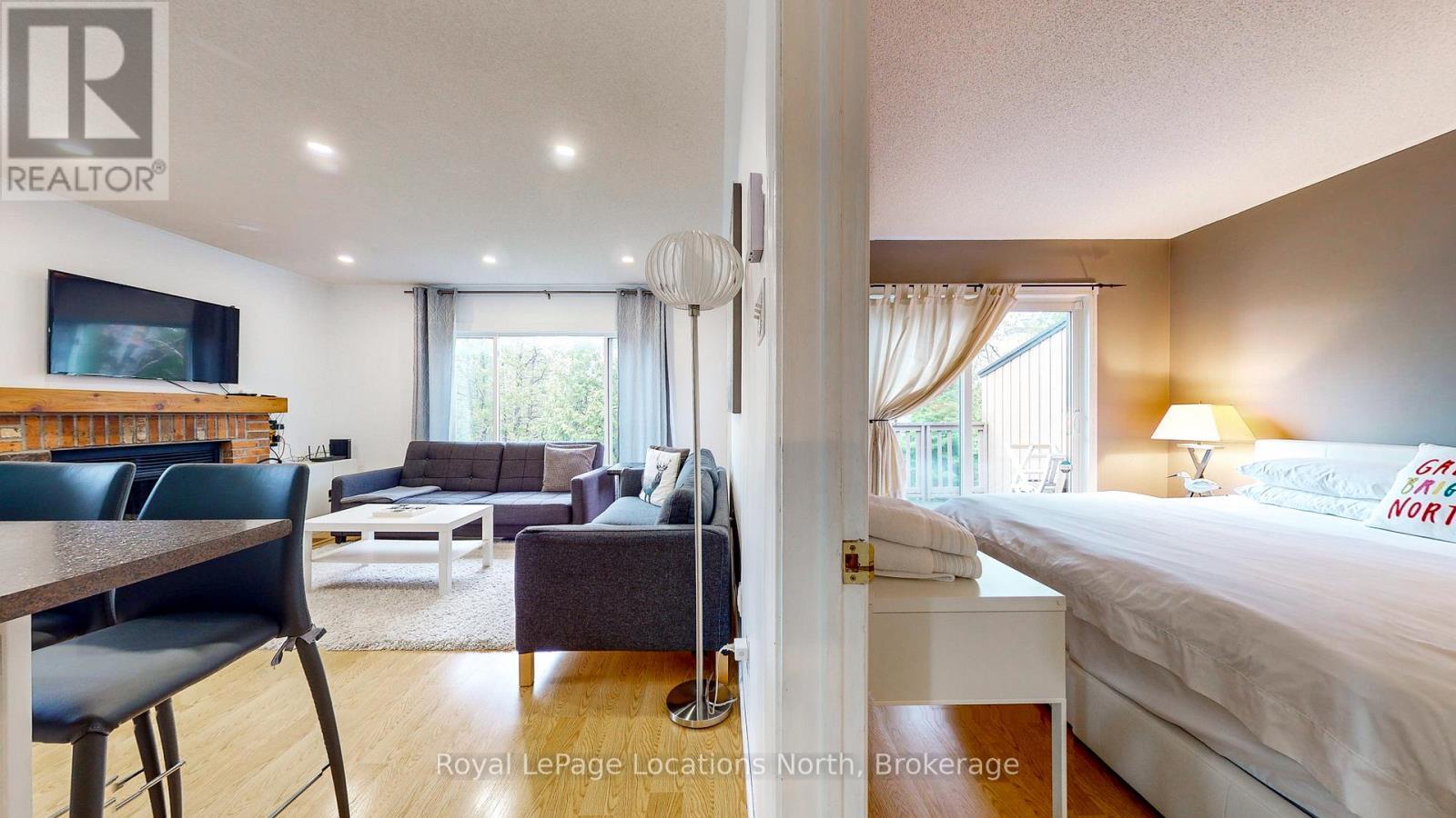 101 - 23 Dawson Drive, Collingwood, ON - Indoor Photo Showing Bedroom With Fireplace