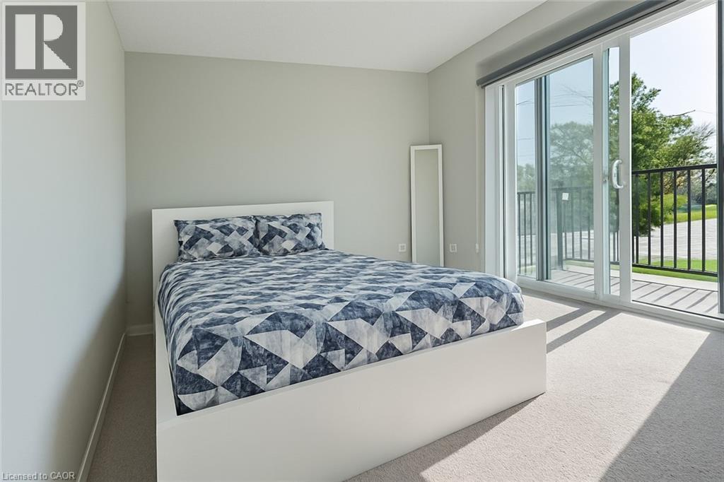 Bedroom featuring carpet floors and access to exterior - 185 Windale Crescent Unit# 5A, Kitchener, ON - Indoor Photo Showing Bedroom
