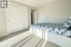 Carpeted bedroom with a closet -