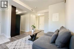 Living area featuring light wood finished floors, a textured ceiling, and electric panel -