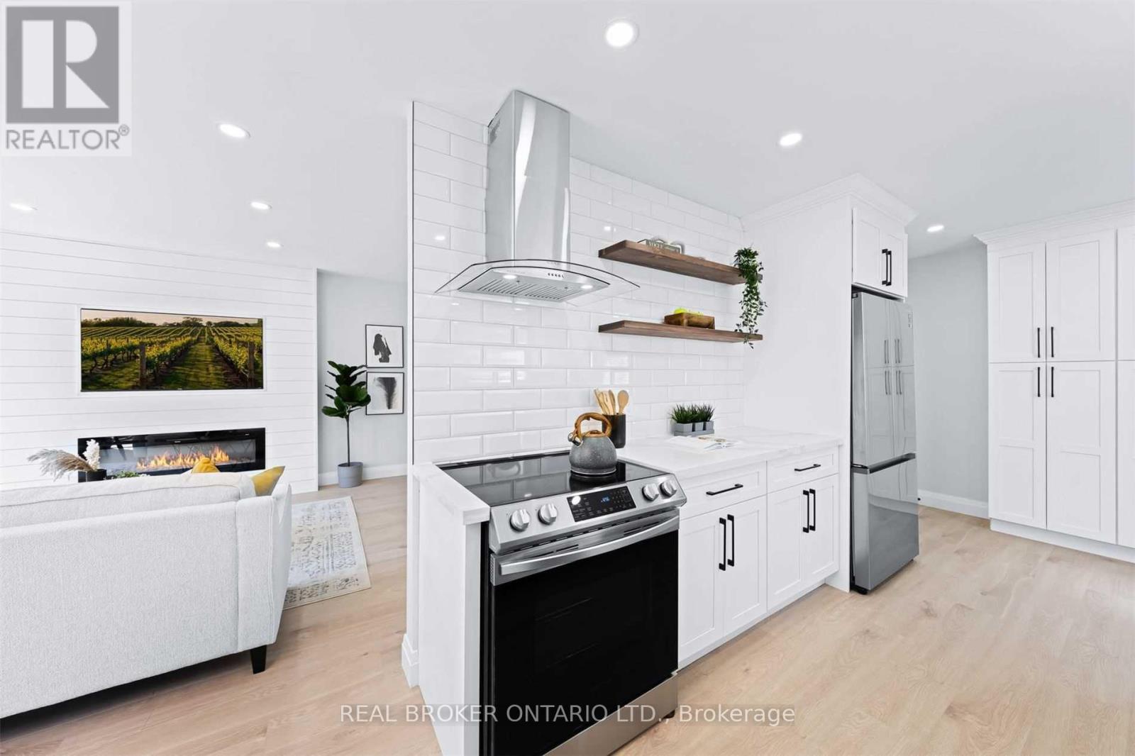 141 Cunningham Drive, New Tecumseth, ON - Indoor Photo Showing Kitchen With Fireplace