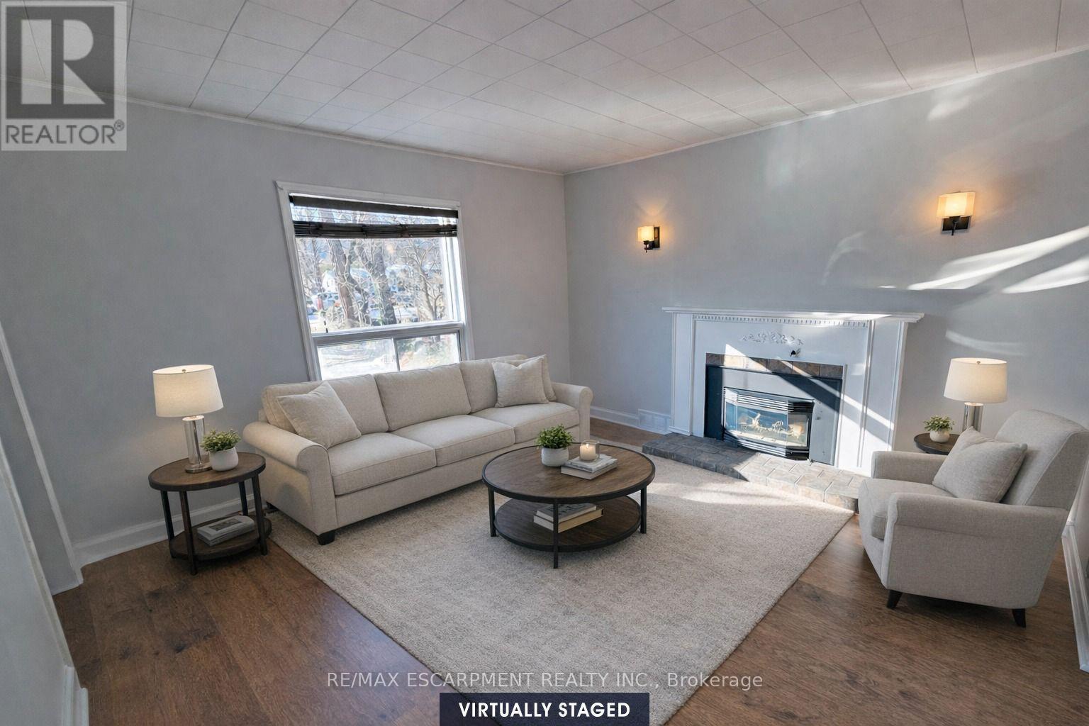 Virtually Staged - Living Room - 205 Main Street E, Grimsby, ON - Indoor Photo Showing Living Room With Fireplace