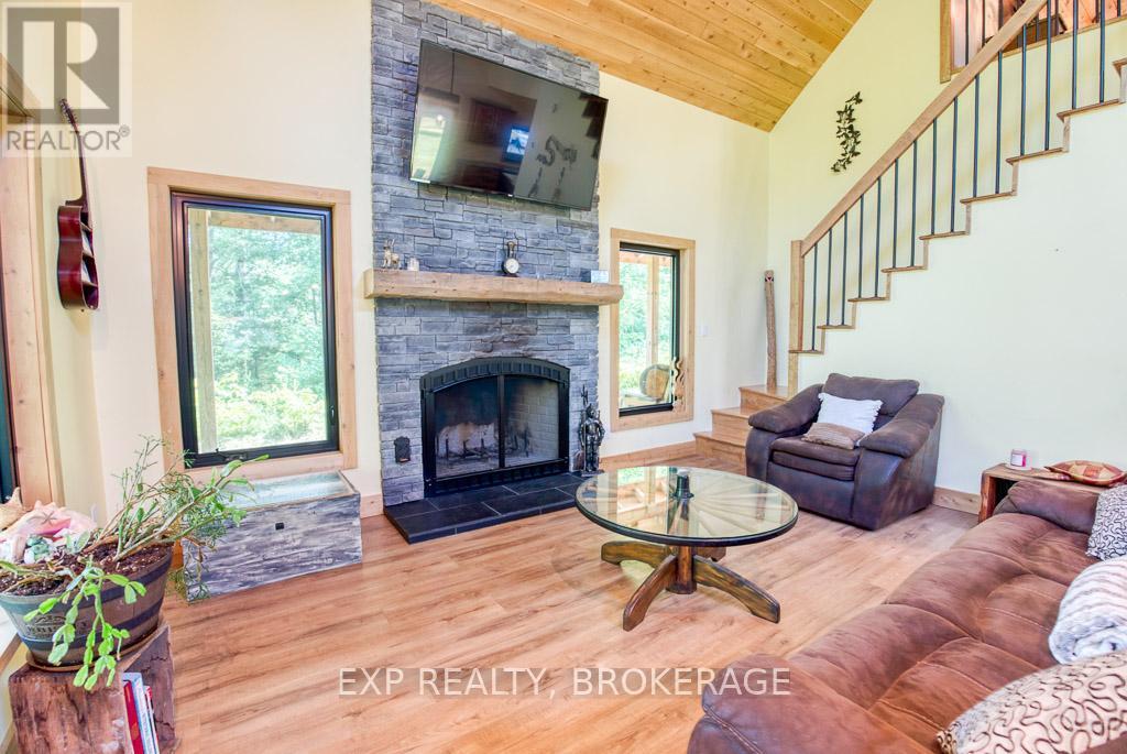 1249 Waters Edge Lane, Frontenac (Frontenac Centre), ON - Indoor Photo Showing Living Room With Fireplace