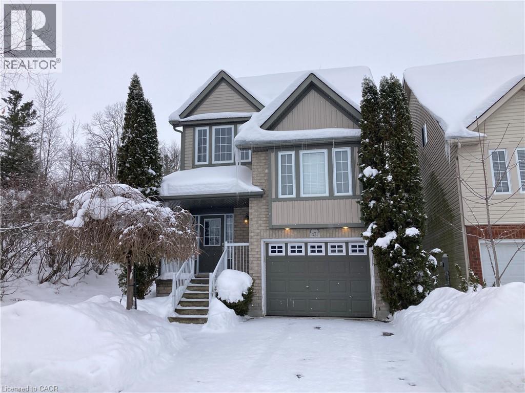 View of front of property featuring a garage and brick siding - 421 White Birch Avenue, Waterloo, ON - Outdoor With Facade