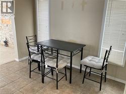 Dining room featuring baseboards and light tile patterned floors -