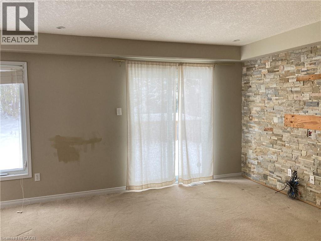 Unfurnished room featuring a textured ceiling and carpet - 421 White Birch Avenue, Waterloo, ON - Indoor Photo Showing Other Room