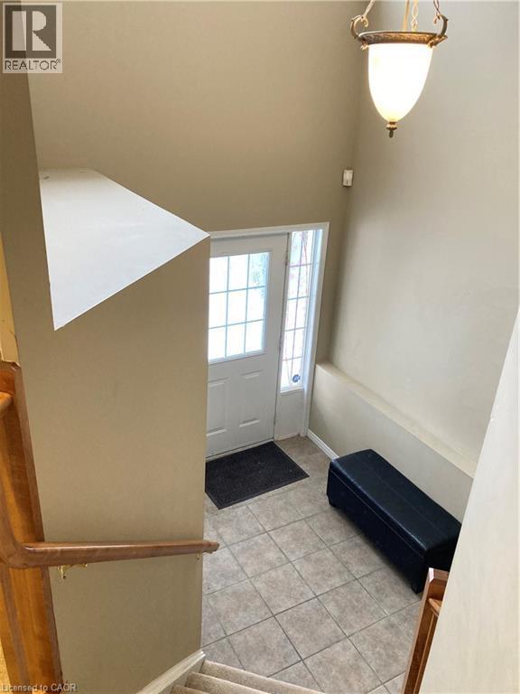 Foyer featuring light tile patterned floors and baseboards - 421 White Birch Avenue, Waterloo, ON - Indoor Photo Showing Other Room