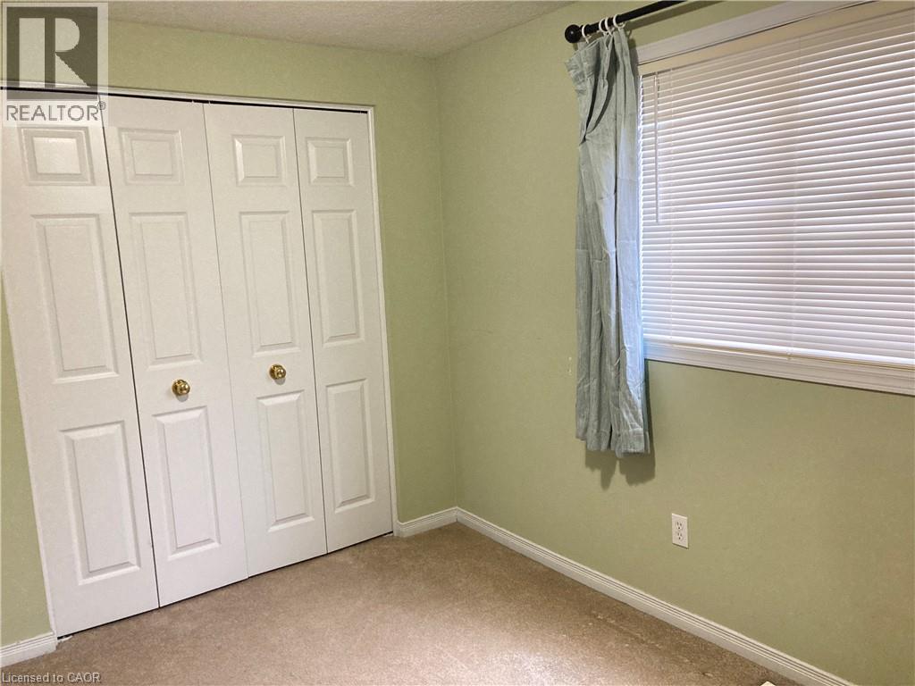 Unfurnished bedroom featuring light colored carpet and a closet - 421 White Birch Avenue, Waterloo, ON - Indoor