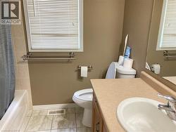 Full bath featuring vanity, light marble finish floors, and shower / bath combo with shower curtain -