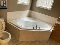 Full bath featuring a jetted tub -