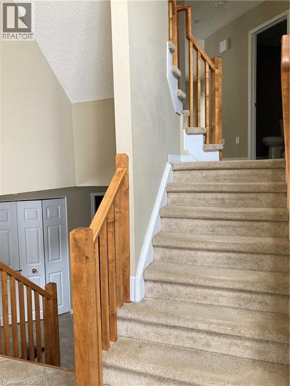 Staircase featuring tile patterned flooring - 421 White Birch Avenue, Waterloo, ON - Indoor Photo Showing Other Room