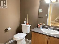 Half bath featuring vanity and light tile patterned floors -