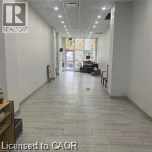 Hallway featuring expansive windows and recessed lighting - 280 Lester Street Unit# 115, Waterloo, ON