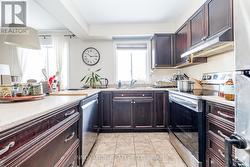 Kitchen appliances 2023, window faces greenspace -