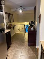 Tile flooring flex space leading into kitchen -