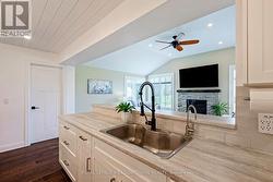 Overlooks cozy living room with fireplace -