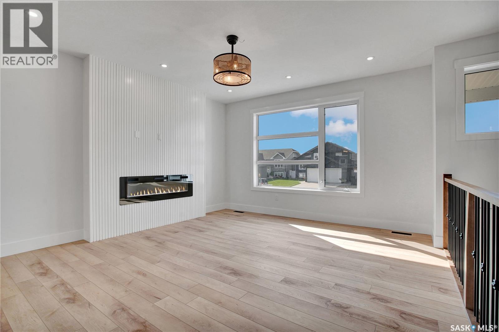 812 Woods Crescent, Warman, SK - Indoor Photo Showing Other Room With Fireplace
