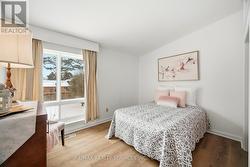 Cozy primary bedroom overlooks backyard -