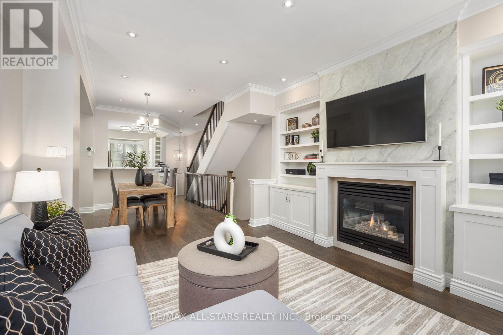 Living Room With Gas Fireplace & Built-In Cabinets - 114 Six Point Road, Toronto, ON - Indoor Photo Showing Living Room With Fireplace
