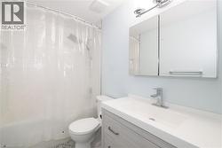 Bathroom with vanity and shower / tub combo with curtain -