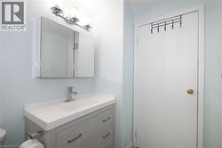 Half bathroom with vanity and toilet -