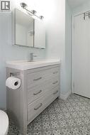 Half bathroom with vanity and toilet -