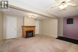 finished rec room featuring a gas fireplace -