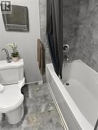 Bathroom featuring shower / bath combo and toilet -