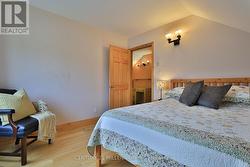 Bedroom 1 (wood floor, window, closet) -