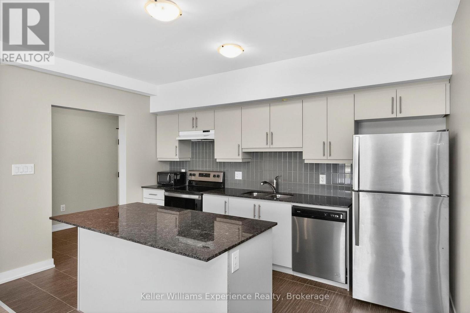 216 - 4 Spice Way, Barrie, ON - Indoor Photo Showing Kitchen With Stainless Steel Kitchen With Double Sink With Upgraded Kitchen
