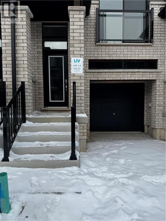 Snow covered property entrance with brick siding - 660 Colborne Street W Unit# 57, Brantford, ON - Outdoor With Fireplace