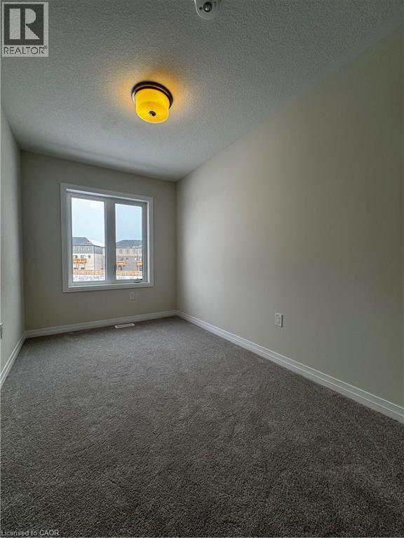 Spare room with a textured ceiling and carpet floors - 660 Colborne Street W Unit# 57, Brantford, ON - Indoor Photo Showing Other Room